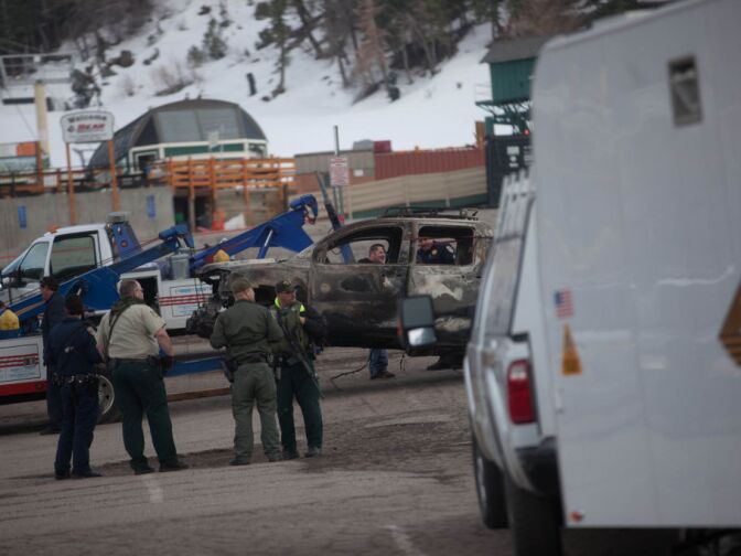 Law enforcement brief at the base of Bear Mountain ski resort, which has been closed all day, because of a massive manhunt for Christopher Dorner.
