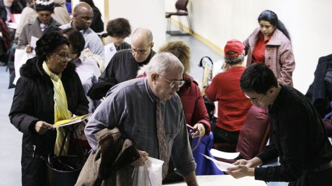 John Pham (right) reviews Bob Drake's resume at an AARP event intended to help older workers improve their job search. 
