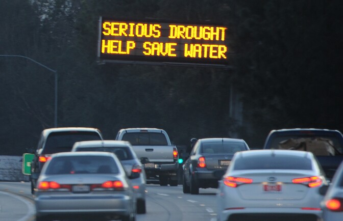 A sign over a highway in Glendale, California warns motorists to save water in response to the state's severe drought, February 14, 2014.  US President Barack Obama is visiting drought-stricken California today and is expected to announce more than $160 million in federal financial aid to help California recover from the crippling drought that is threatening the state's agriculture industry. AFP PHOTO / ROBYN BECK        (Photo credit should read ROBYN BECK/AFP/Getty Images)