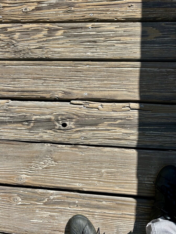 Wood boards side by side. There are splinters in the wood.