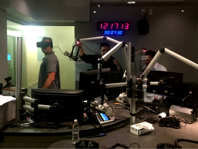 A Martinez watches a virtual reality video on an Oculus headset. To his right are Steve Holtzman and Daniel Gregoire from Matter VR.