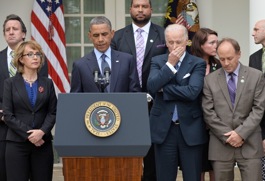 US President Barack Obama is accompanied by former lawmaker Gabrielle Giffords (L), vice president Joe Biden (R) and family members of Newtown school shooting victims as he speaks on gun control at the Rose Garden of the White House in Washington, DC, on April 17, 2013.