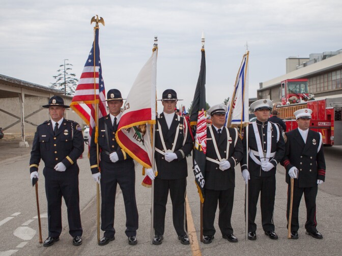 Firefighters participate in a memorial for Christopher MacKenzie, 20, and Kevin Woyjeck, 21, arrive at Los Alamitos Airfield in Orange County.