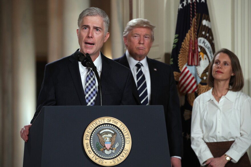 File:  Judge Neil Gorsuch delivers brief remarks after being nominated by U.S. President Donald Trump to the Supreme Court with his wife Marie Louise Gorshuch during a ceremony in the East Room of the White House January 31, 2017 in Washington, DC.