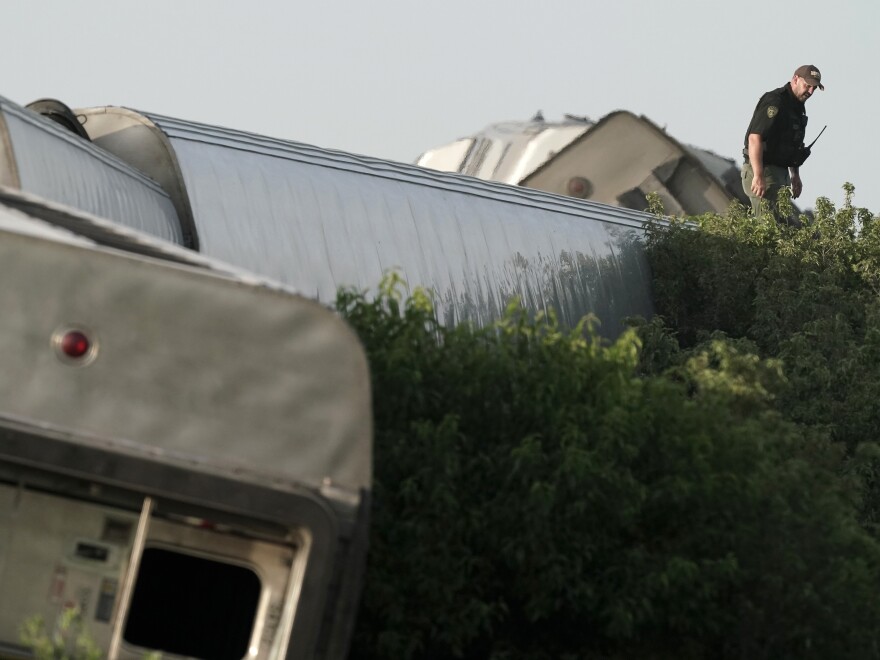 A law enforcement officer inspects the scene.