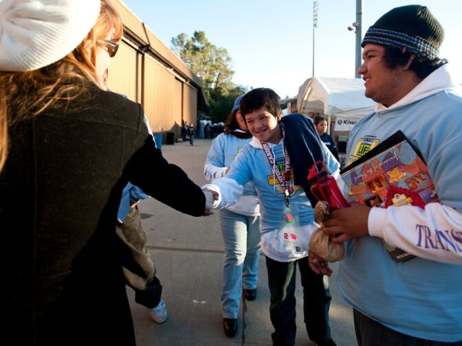Briana Pastorino, left, of Yucaipa says goodbye to 12-year-old Ernesto Bravo Chavez after spending the day working on the float. The family will return again the next day.