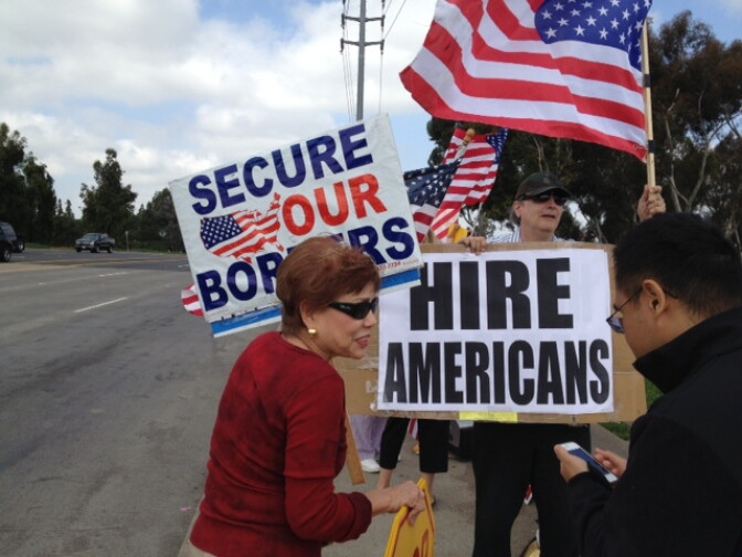 About two dozen protesters rallied for stricter border enforcement on May Day.