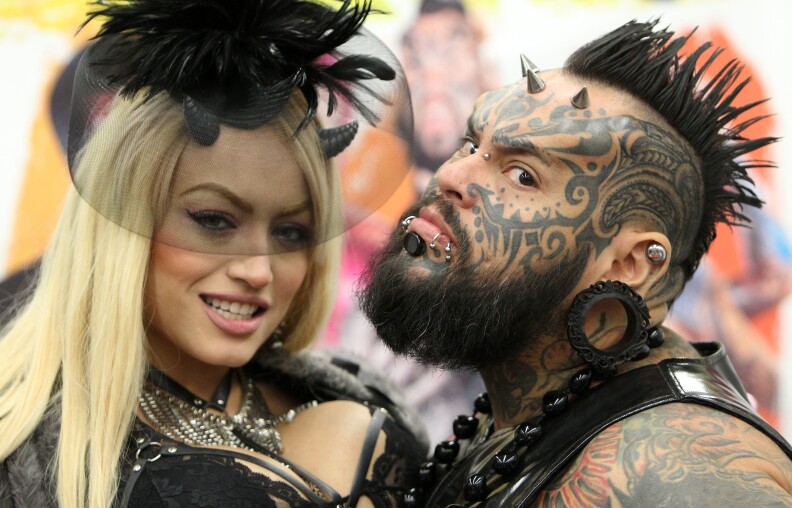 Tattoo artists pose for a picture at the 25th international Tattoo Convention in Frankfurt, Germany, on April 22, 2017.
