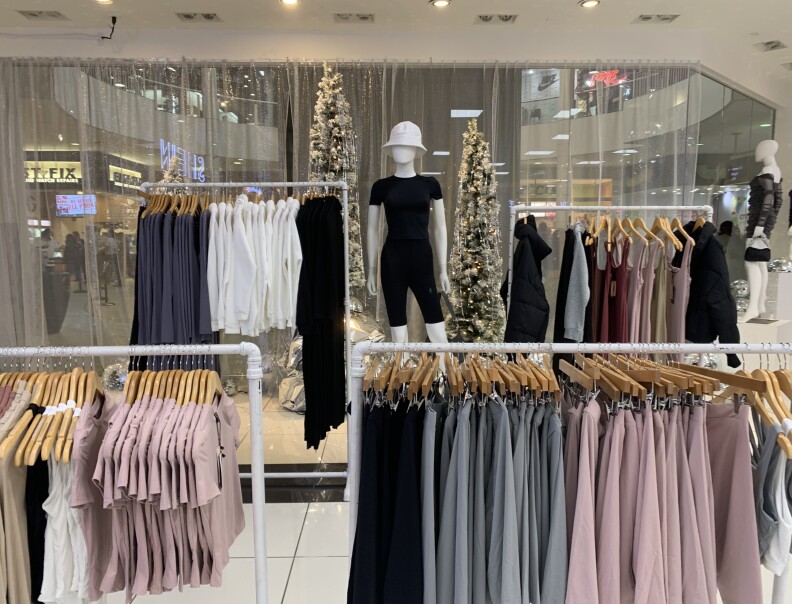 A mannequin stands amid racks of clothing at the Shein pop-up store.