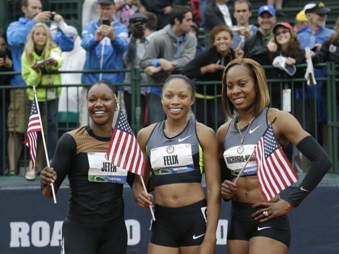 Carmelita Jeter, left, Allyson Felix, center, and Sanya Richards-Ross celebrate making the Olympic team after the women's 200 meters at the U.S. Olympic Track and Field Trials Saturday, June 30, 2012, in Eugene, Ore.