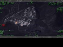 Fire activity is indicated by lighter spots on a dark satellite view.