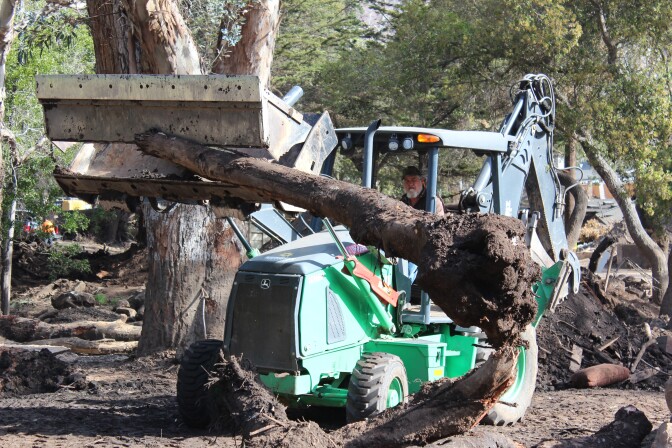 On Thurs., March 8, 2018, cleanup crews worked to clear tree trunks swept downhill from a debris flow in Montecito two months earlier.