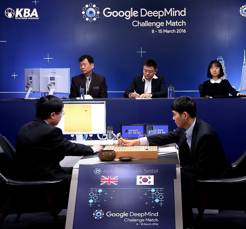 SEOUL, SOUTH KOREA - MARCH 10:  In this handout image provided by Google, South Korean professional Go player Lee Se-Dol (R) puts his first stone against Google's artificial intelligence program, AlphaGo, during the Google DeepMind Challenge Match on March 10, 2016 in Seoul, South Korea. Lee Se-dol is playing a five-match series against a computer program developed by a Google, AlphaGo.  (Photo by Google via Getty Images)