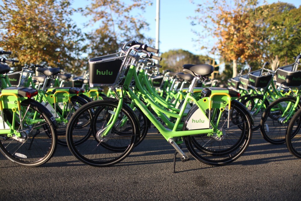 Multiple bikes with Hulu branding lined up in rows outside.
