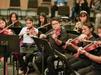 A group of children playing violins 