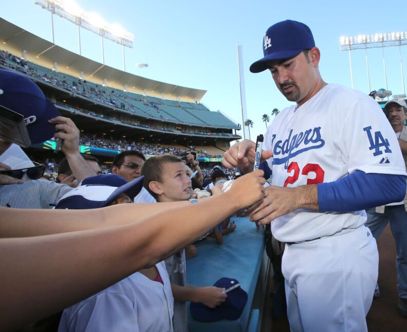 LOS ANGELES, CA - AUGUST 25:  First baseman Adrian Gonzalez #23 of the Los Angeles Dodgers signs autographs before the game with the Miami Marlins on August 25, 2012 at Dodger Stadium in Los Angeles, California.  (Photo by Stephen Dunn/Getty Images)