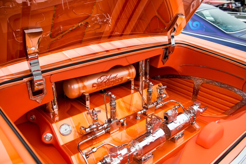 The trunk of Jesse Saldana's 1965 Chevrolet Impala Super Sport is home to the hydraulic pumps that make its chassis move up and down.
