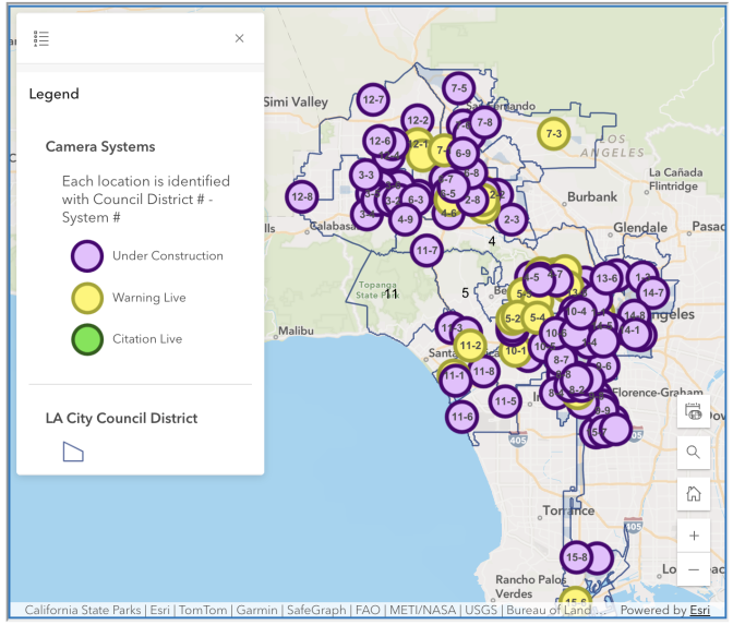 A Los Angeles map shows traffic camera locations by council district, mostly marked purple for under construction, with some yellow for active warnings.