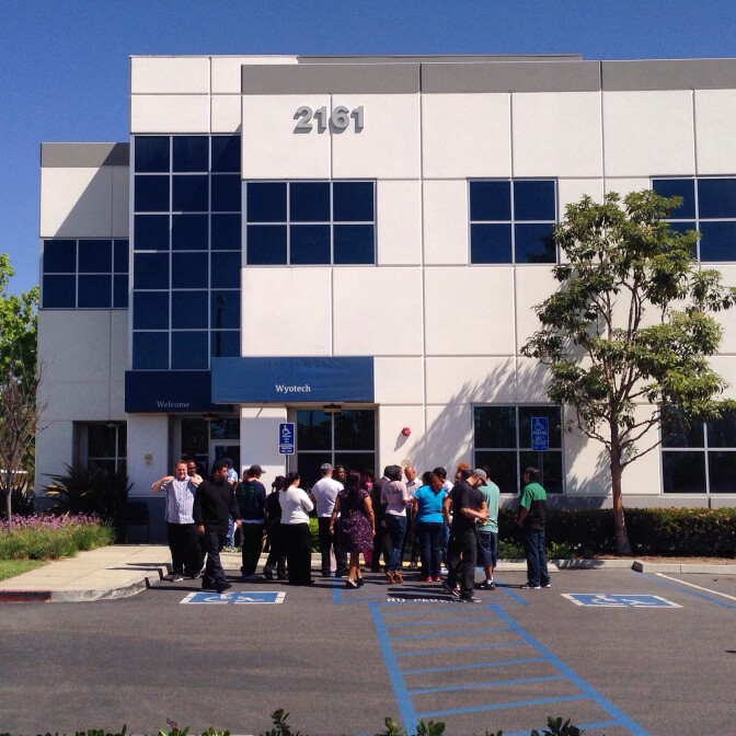 Officials at WyoTech, a Corinthian Colleges campus, talk to students on the day their campus shut down.  