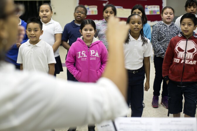 Fourth graders practice "Este Es La Navidad" for their upcoming holiday performance at Martin Luther King Elementary School in Compton on Friday morning, Dec. 5, 2014.