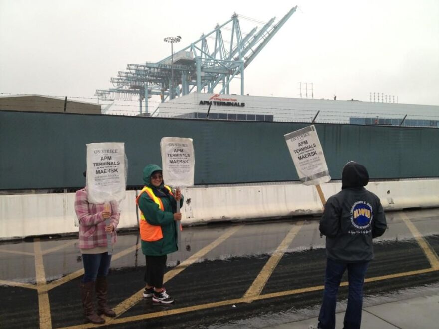 Striking clerical workers at Pier 400 walk the picket lines Thursday at the Port of Los Angeles.