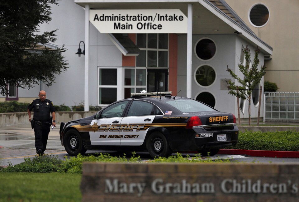 A San Joaquin County Sheriff's deputy walks back to his car after responding to a call to Mary Graham Children's Shelter April 6, 2017 in French Camp, Calif.