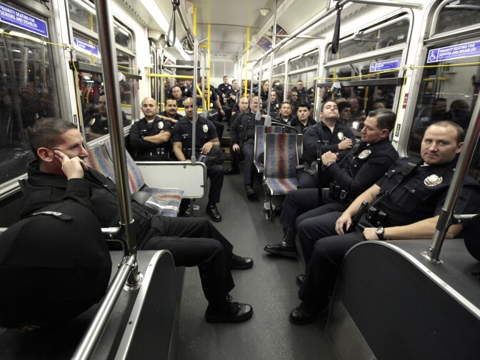 Los Angeles Police Department officers wait on a bus to transport them to the Occupy LA encampment outside Los Angeles City Hall to evict protesters on November 29, 2011 in Los Angeles California. Protesters remain on the City Hall lawn despite a deadline, set by Los Angeles Mayor Antonio Villaraigosa, to dismantle their campsite and leave the park which the city declared will be closed as of 12:01 am November 28th. 