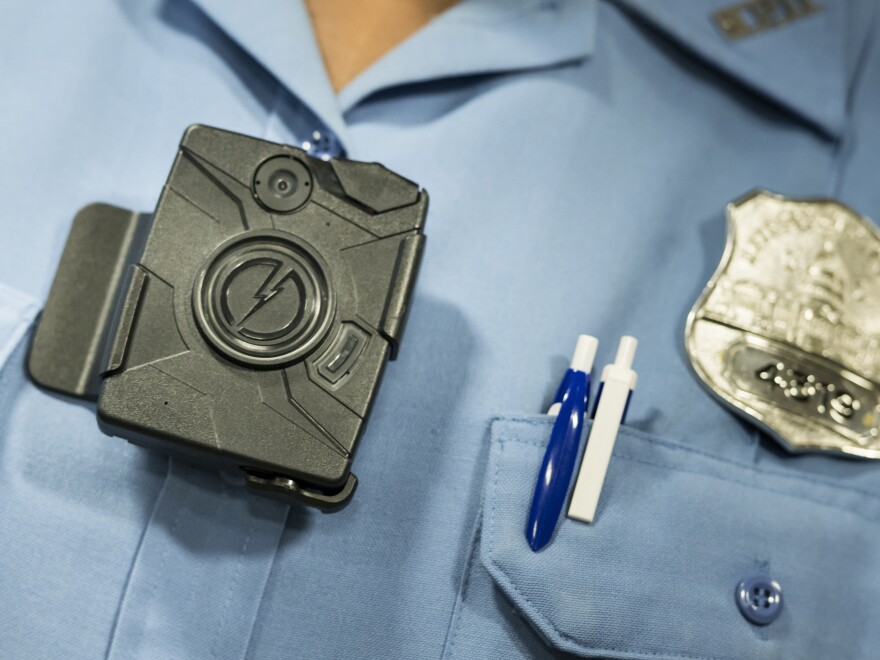 Body cameras, like this one shown at a 2014 press conference in Washington, D.C., are small enough to be clipped to an officer's chest. Washington and Denver are among U.S. cities trying the cameras.