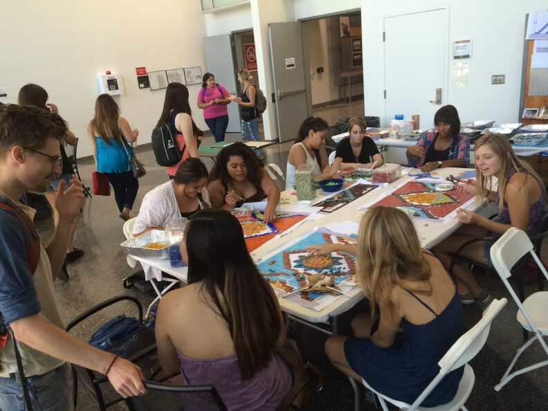 Students and community gather to help with mosaics for Azusa Downtown station.