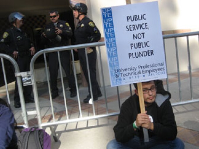 UCLA sociology major Adrian Corral protests outside a University of California Regents meeting at UCLA. Corral was among some 1,000 students and UC employees protesting on Wednesday a plan to increase student fees 32 percent. The University of California's full Board of Regents is expected to approve the fee hike tomorrow.