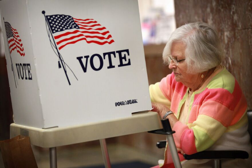 Liz Poole, whose first experience with politics was campaigning for President Franklin D. Roosevelt as a child, fills in her ballot during early voting at the Black Hawk County Courthouse on September 27, 2012 in Waterloo, Iowa. Early voting starts today in Iowa where in the 2008 election 36 percent of voters cast an early ballot.  