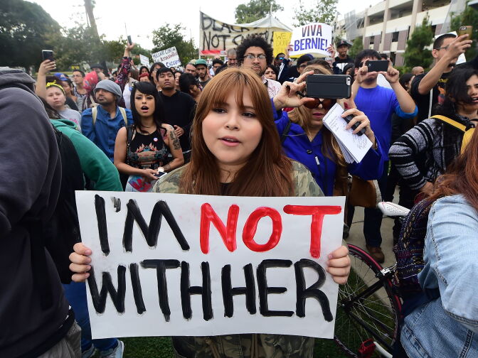 Protesters from Latino and Community groups make their way to East Los Angeles College in Monterey Park on May 5, 2016 to protest U.S. Democratic presidential candidate Hillary Clinton. Clinton campaigned in the Los Angeles area ahead of California's June 7 primary.