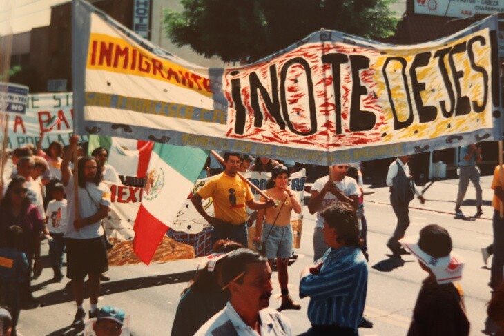 Marches carry a banner and Mexican flags