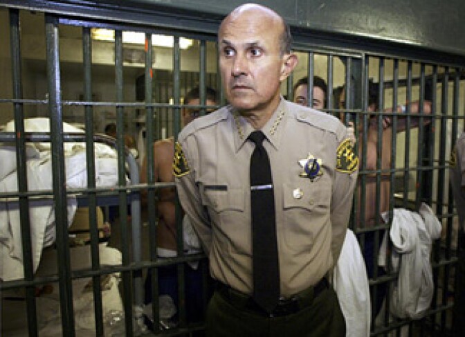 Overcrowding at the Los Angeles County Jails has been an issue for years. In this photo, Sheriff Lee Baca talks with reporters as he leads a tour inside the Men's Central Jail at the Twin Towers Correctional Facility in Los Angeles, Wednesday, May 19, 2004. At that time, he faced criticism over a spate of deaths in the country's largest jail.
