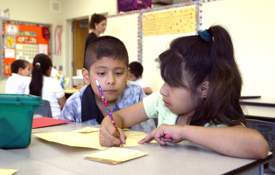 Students work together in teacher Daisy Moran's second-grade bilingual class during summer school at Mozart School July 2, 2003 in Chicago, Illinois. 
