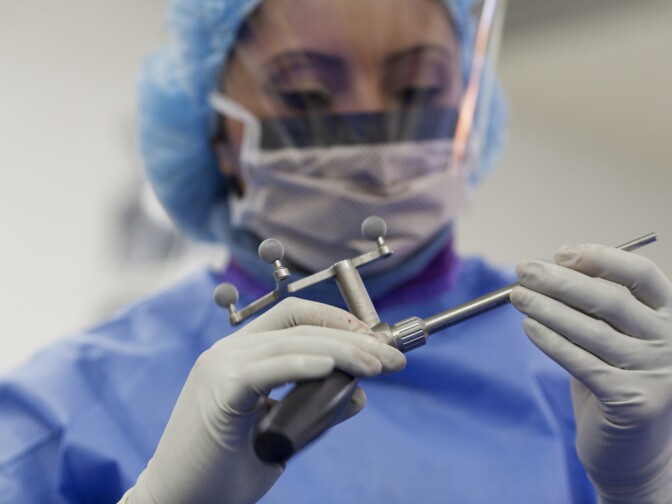 Surgical Technician Daniela Barrio prepares equipment before a spinal surgery at Foothills Presbyterian Hospital in Glendora. The surgeon Barrio was working with is not part of a physician-owned distributorship,  but the practice of surgeons using implants that they have a financial interest in under scrutiny from the Department of Health and Human Services.