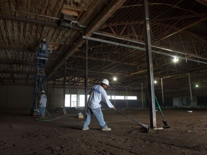 Lorenzo Esteban grades the floor of the future 28,000-square-foot Walmart Neighborhood Market in Altadena, Calif.