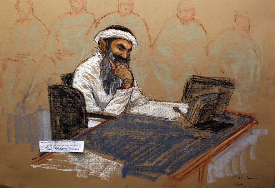 In this courtroom drawing reviewed and approved for release by a US military security official, Khalid Sheikh Mohammed sits in court on May 5, 2012 at the US Naval Base in Guantanamo Bay, Cuba. Mohammed, self-confessed mastermind of the 9/11 attacks, and four co-defendants appeared in a in court to be arraigned, all facing the death penalty if convicted. Mohammed and the other accused plotters challenged the court with small acts of defiance before being formally charged with planning and executing the September 11, 2001 attacks. The suicide attacks by Al-Qaeda militants in hijacked airliners killed 2,976 people in New York, Washington and Shanksville, Pennsylvania.