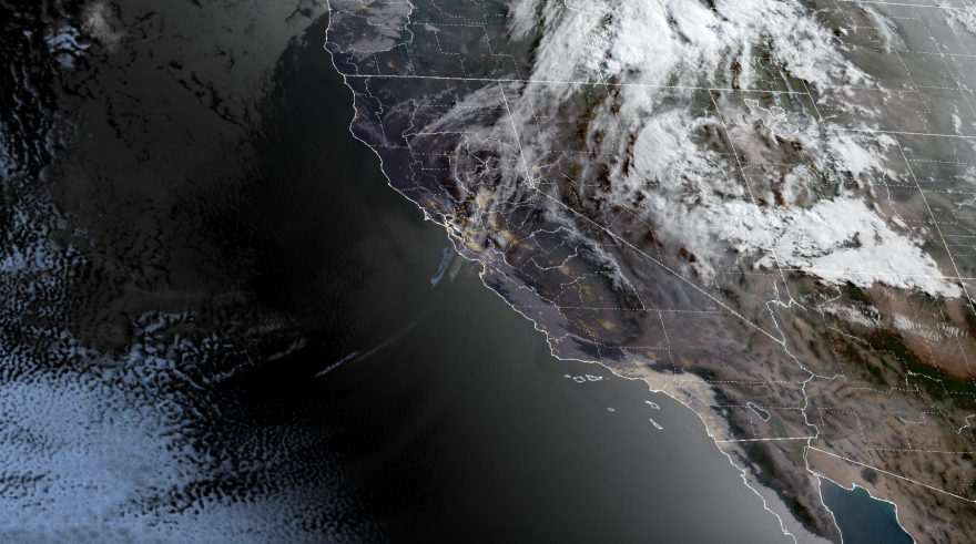 A weather map of California and the surrounding states and ocean. The map is mostly black with patches of white over Nevada and further north.