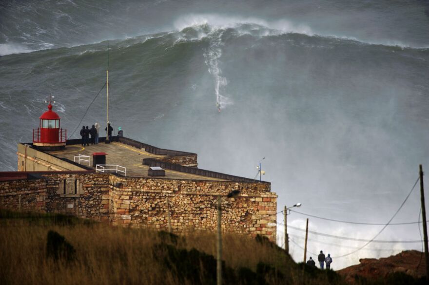 This photo released Tuesday Jan. 29, 2013, by Nazare Qualifica organization, US surfer Garrett McNamara rides a wave off Praia do Norte beach in Nazare, Portugal, on Monday Jan. 28, 2013.  McNamara is said to have broken his own world record for the largest wave surfed when he caught this wave reported to be around 100ft, off the coast of Nazare on Monday.  If the claims are verified, it will mean that McNamara, who was born in Pittsfield, Massachusetts but whose family moved to Hawaii's North Shore when he was aged 11, has beaten his previous record, which was also set at Nazare, of 23.77 meters (78 feet) in November 2011. 