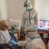 PALLEJÀ, SPAIN - MAY 21: Primary health care nurse Jose Dominguez (C) and physician Joan Maria Farré (C) both in personal protective equipment (PPE) speak with Pilar Boxo who is in quarantine after being tested positive of COVID-19 during a monitoring visit to COVID19 patients at Yayo Toni on May 21, 2020 in Pallejà, Spain. As figures of deaths and infection rates are at their lowest since the start of the outbreak in Spain, the primary health care network will be crucial for filtering and monitoring COVID-19 patients, in order to protect Spanish hospitals from becoming over-crowded. This task will be especially intense across Spain's nursing homes, where more than 18,000 elderly people have died due to the Coronavirus  (COVID-19) pandemic. (Photo by David Ramos/Getty Images)