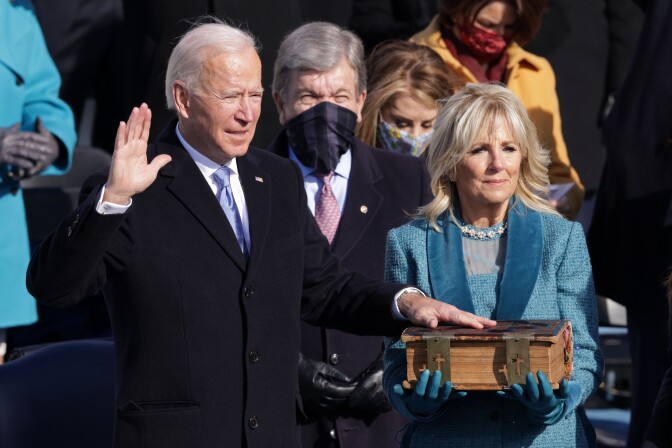 WASHINGTON, DC - JANUARY 20: Joe Biden is sworn in as U.S. President as his wife Dr. Jill Biden looks on during his inauguration on the West Front of the U.S. Capitol on January 20, 2021 in Washington, DC.  During today's inauguration ceremony Joe Biden becomes the 46th president of the United States. (Photo by Alex Wong/Getty Images)