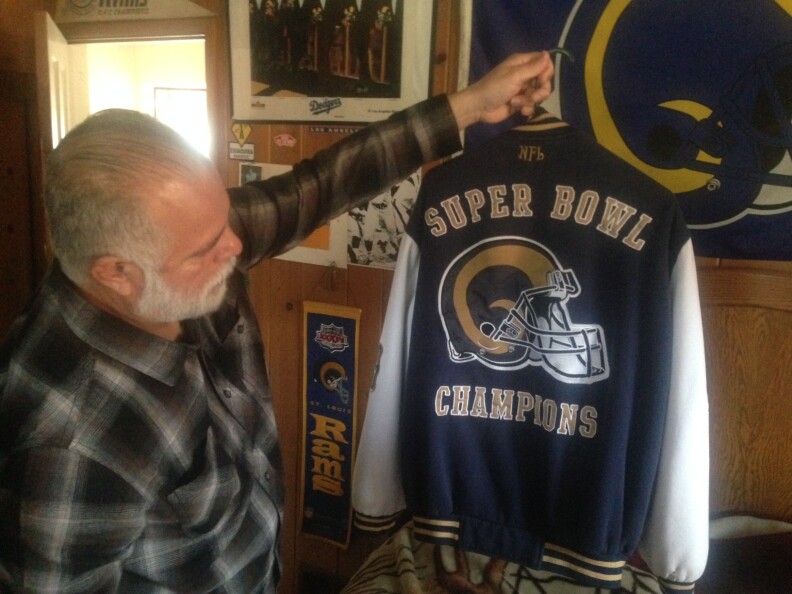 Ernie Garcia showing off one of his prized possessions, his authentic Rams letterman's jacket