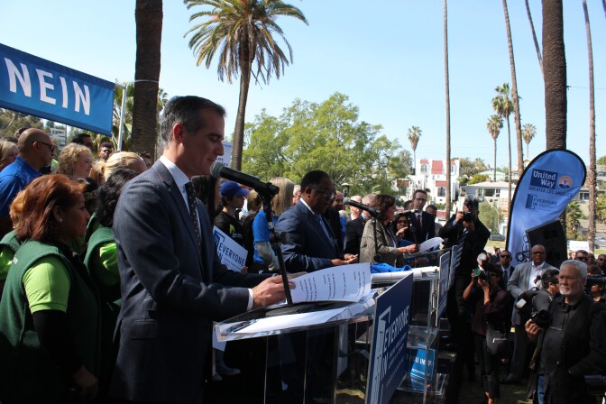 Mayor Eric Garcetti (left) and L.A. County supervisors Mark Ridley-Thomas (center) and Supervisor Hilda Solis (far right) speak during the launch event for an anti-homelessness campaign in Echo Park on Fri., Mar. 9, 2018.