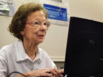 Suzette D'Hooghe, 77, works on her laptop computer during a computer class in Des Plaines, Ill., in 2003. Increasing numbers of people older than 50 are turning to social networking to share updates and connect with family and friends.  