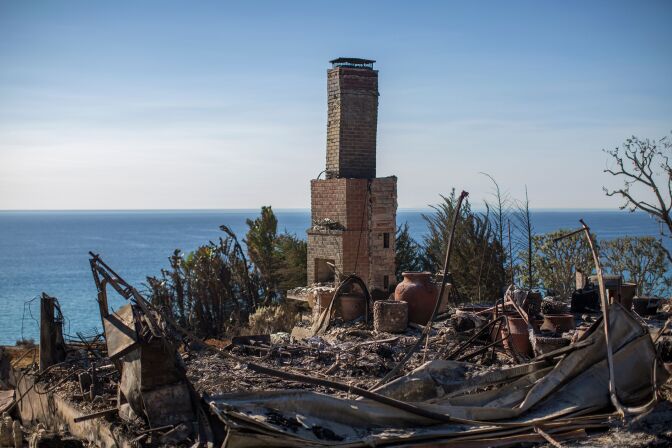 The ruins of an ocean view home are seen in the aftermath of the Woolsey Fire in Malibu, California on November 14, 2018. - Firefighters backed by air tankers and helicopters battled California's raging wildfires for a seventh day on Wednesday as the authorities in the worst-hit county released a list of over 100 missing people. Cal Fire said more than 3,500 fire personnel were battling the "Woolsey Fire," which has destroyed the Malibu homes of several celebrities including Miley Cyrus, Neil Young, Robin Thicke, Shannen Doherty and Gerard Butler. At least 51 deaths have been reported so far from the deadliest wildfires in California's recent history and body recovery teams were going house-to-house with cadaver dogs in Paradise. (Photo by DAVID MCNEW / AFP)        (Photo credit should read DAVID MCNEW/AFP/Getty Images)