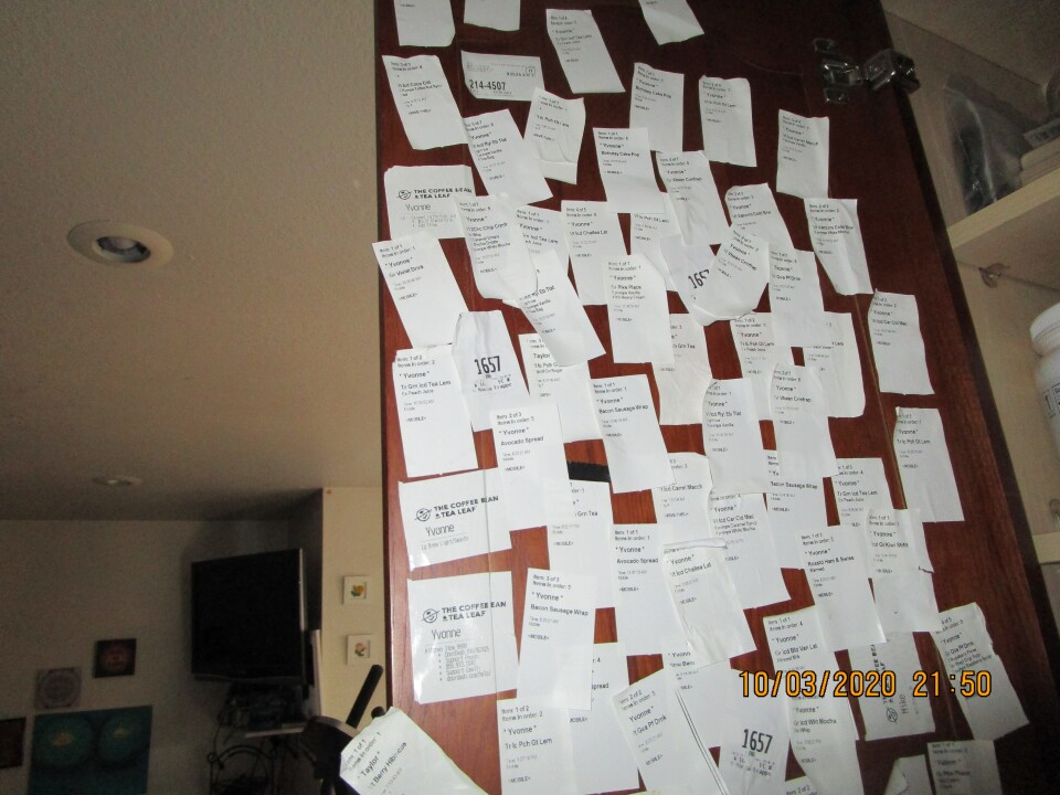 This is an image of many small white receipts from Starbucks pasted on a wall.