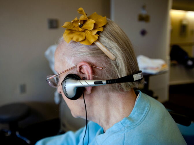 Eighty-seven-year-old Mimi P. listens to music on Thursday, Jan. 24 in a recreation room. Music genres range from classical to Christian, to Frank Sinatra and The Temptations.