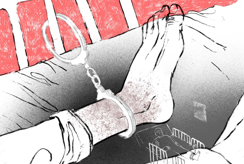 An illustration mostly in black and white shows a person's foot handcuffed to bed rails, with a red background behind the rails.