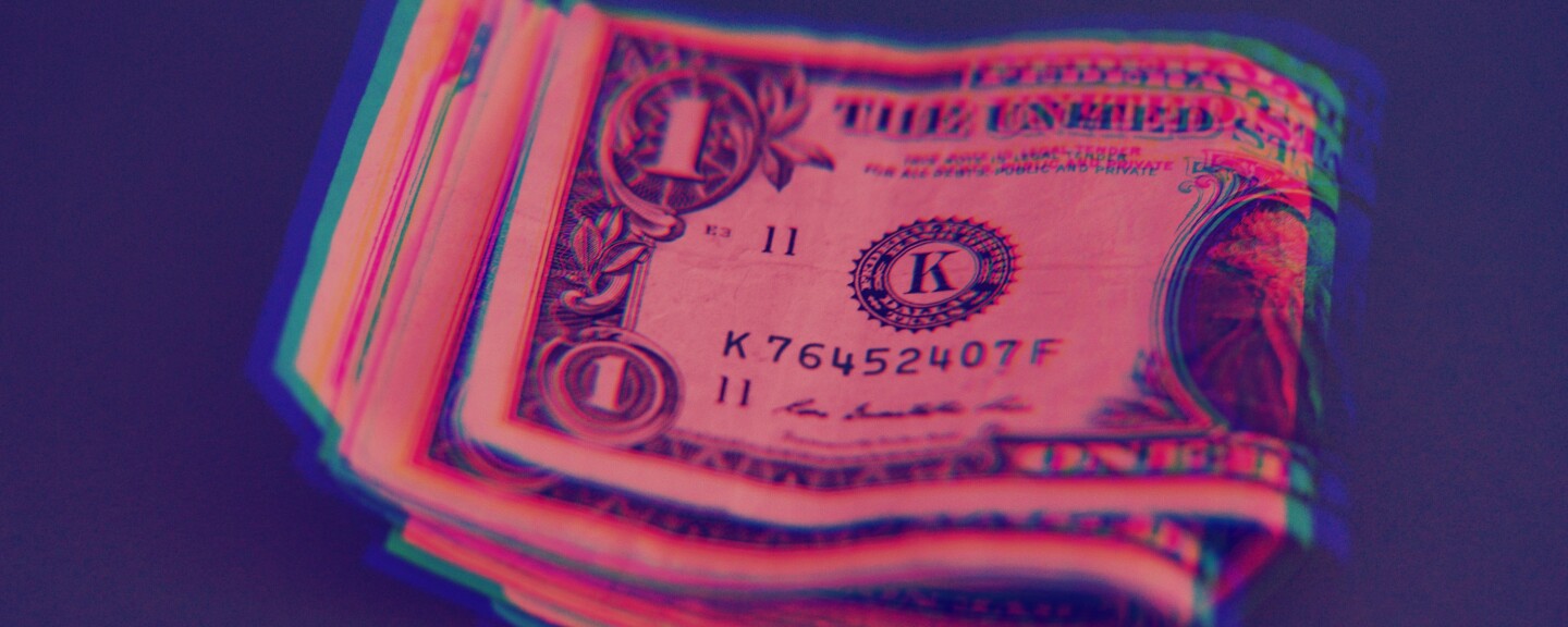 An illustration depicts a wad of dollar bills.